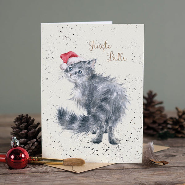 A Christmas greeting card that features a furry cat wearing a Christmas cap