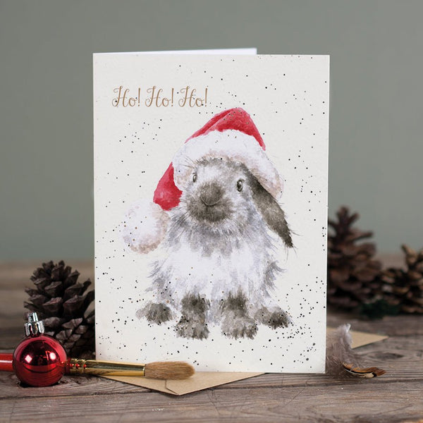 A Christmas greeting card featuring a bunny wearing a Christmas cap