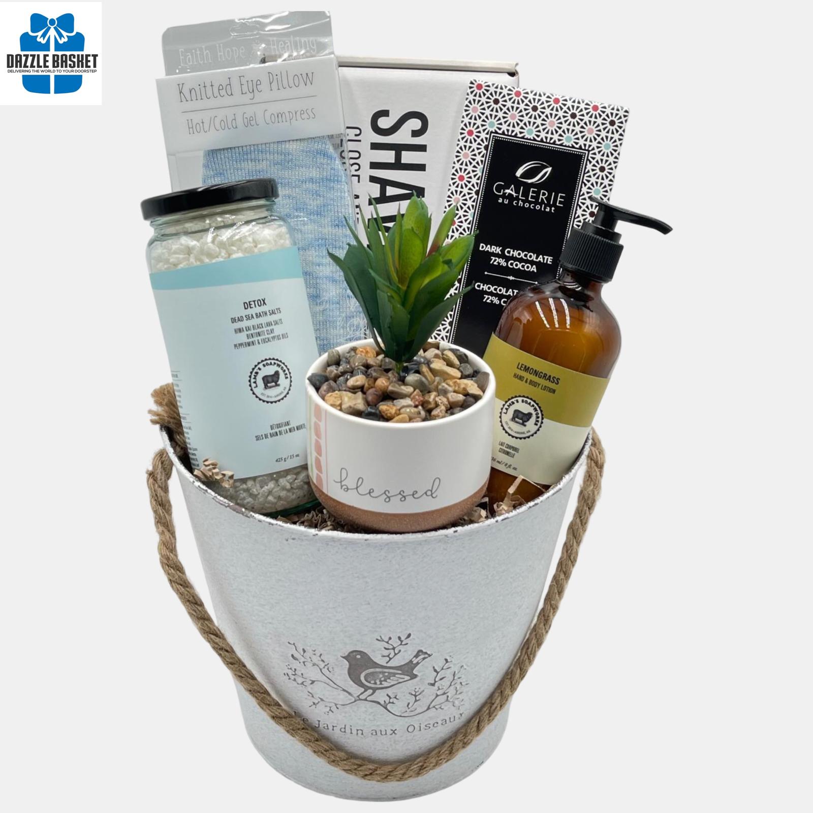 A Calgary spa gift basket with top of the line spa products & chocolate arranged in a white round metal basket.