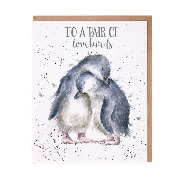 An Anniversary greeting card that has a picture of two penguins cuddling.