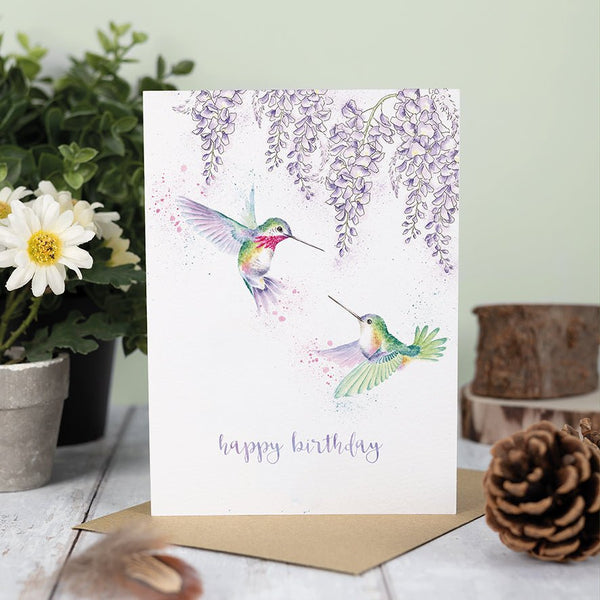 A birthday greeting card that depicts two beautiful birds on the front and carries the text "Happy Birthday"