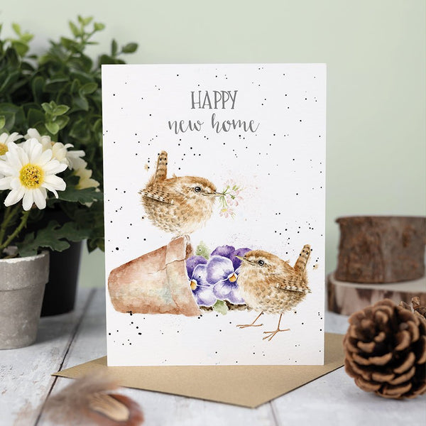 A new homeowner greeting card that shows 2 little birds around a flowerpot.