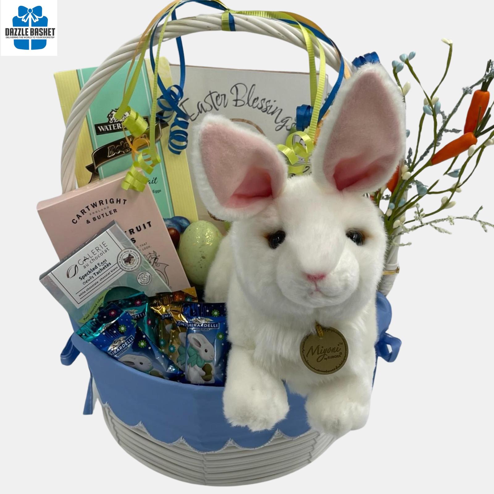 A Calgary Easter gift basket with large bunny plush toy and  themed chocolates and gourmet snacks arranged beautifully in a white basket with handle.