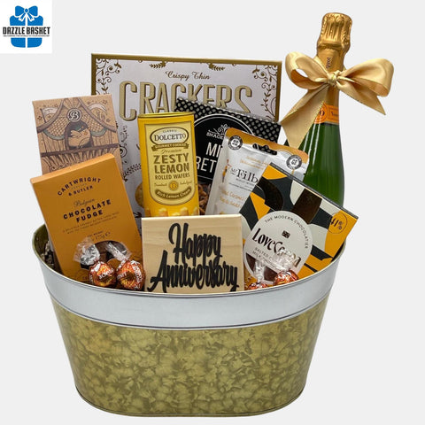 Calgary's finest anniversary gift basket that includes a bottle of champagne with delicious food snacks. This basket is made in a metal golden container.