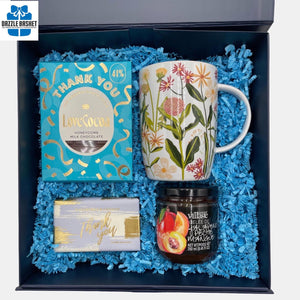 An elegant Calgary Thank you Gift basket that contains classic products including a coffee mug, "Thank you" soap & chocolate  in a  reusable blue box 