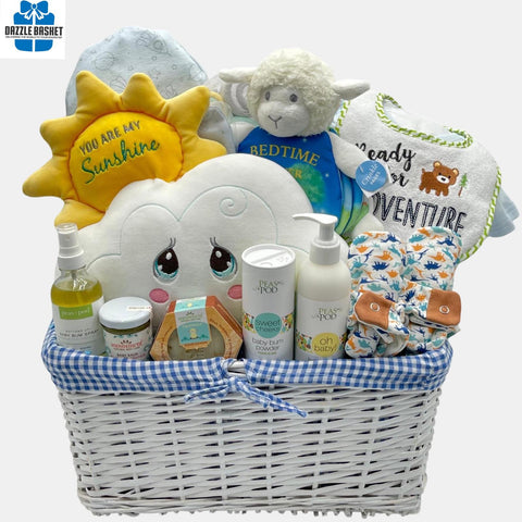 A baby boy gift basket that includes quality baby products including blanket, onesie, shoes and a beautiful "You are my Sunshine" plush toy packed in a lovely white basket. with blue liner.