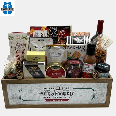 An array of holiday gourmet snacks with an award winning bottle of wine arranged neatly in a holiday themed wooden crate