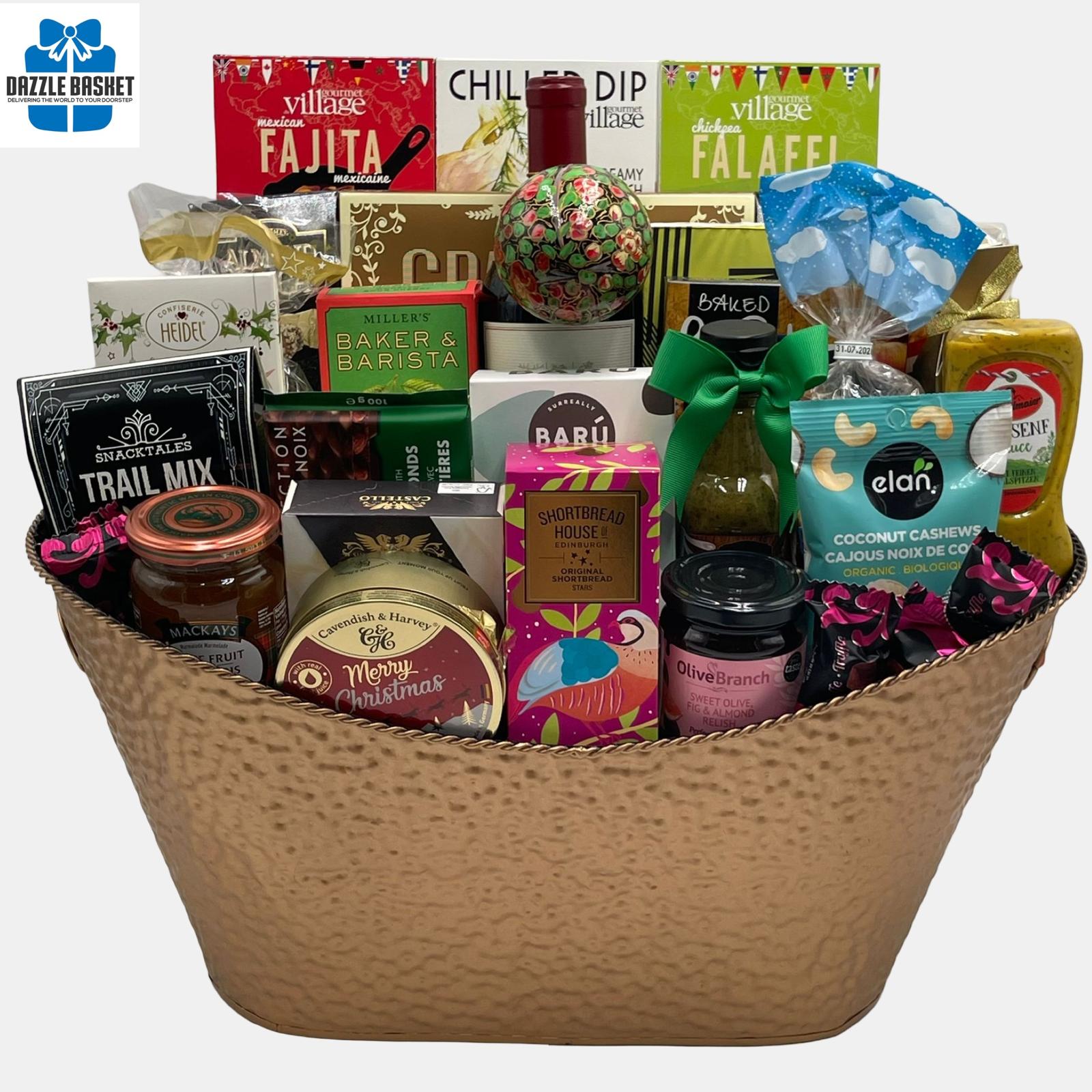 A gigantic Calgary gift basket with a bottle of wine, quality gourmet snacks and a lovely handpainted, Christmas tree ornament arranged in an innovative manner in an extra large metal basket.