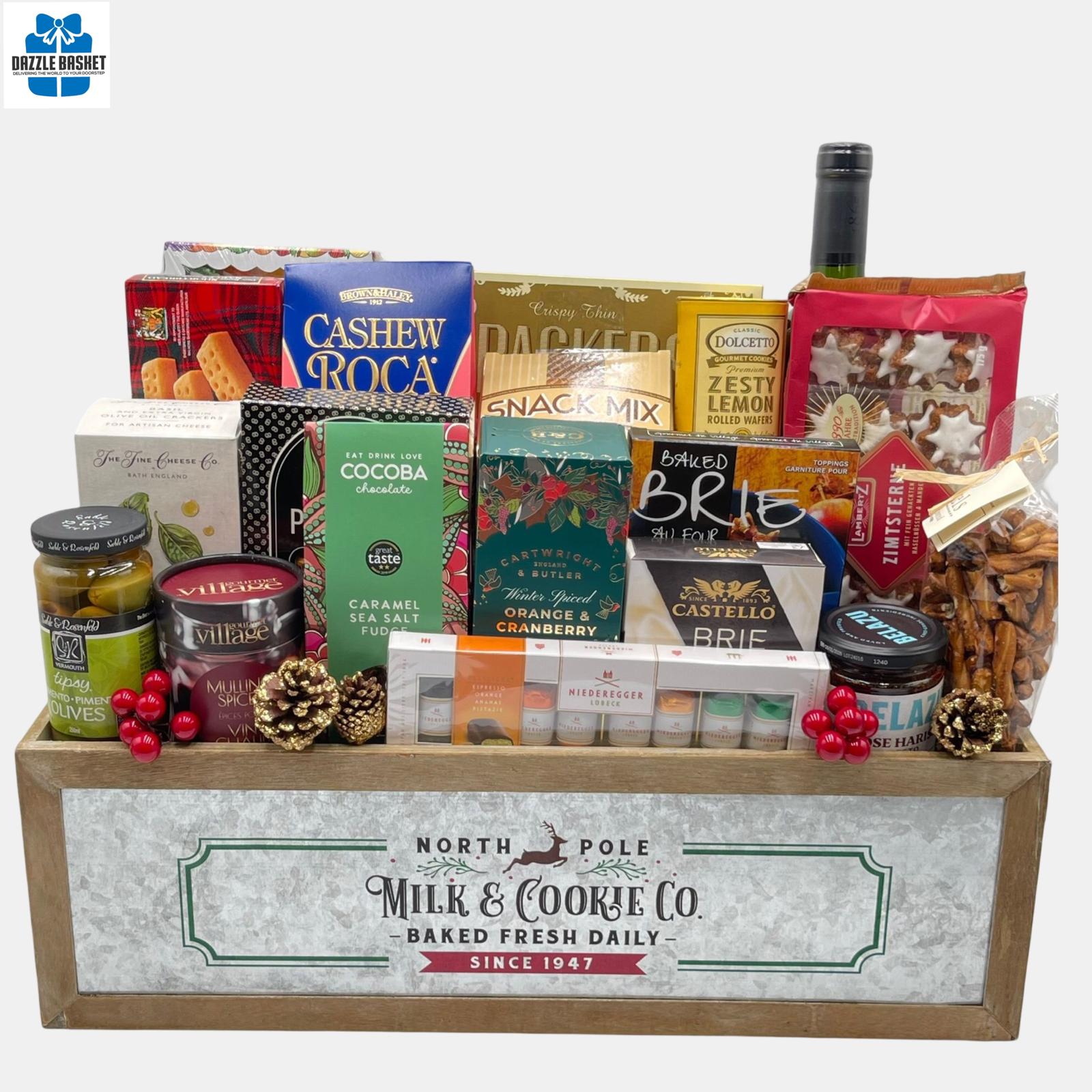 An array of holiday gourmet snacks with an award winning bottle of wine arranged neatly in a holiday themed wooden crate