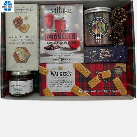 A Calgary gift box with gourmet food neatly arranged in a Holiday themed box.