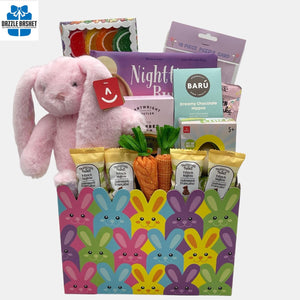 A Calgary Easter gift basket with Easter bunny plush toy and themed chocolates and gourmet snacks arranged beautifully in a bunny themed box.