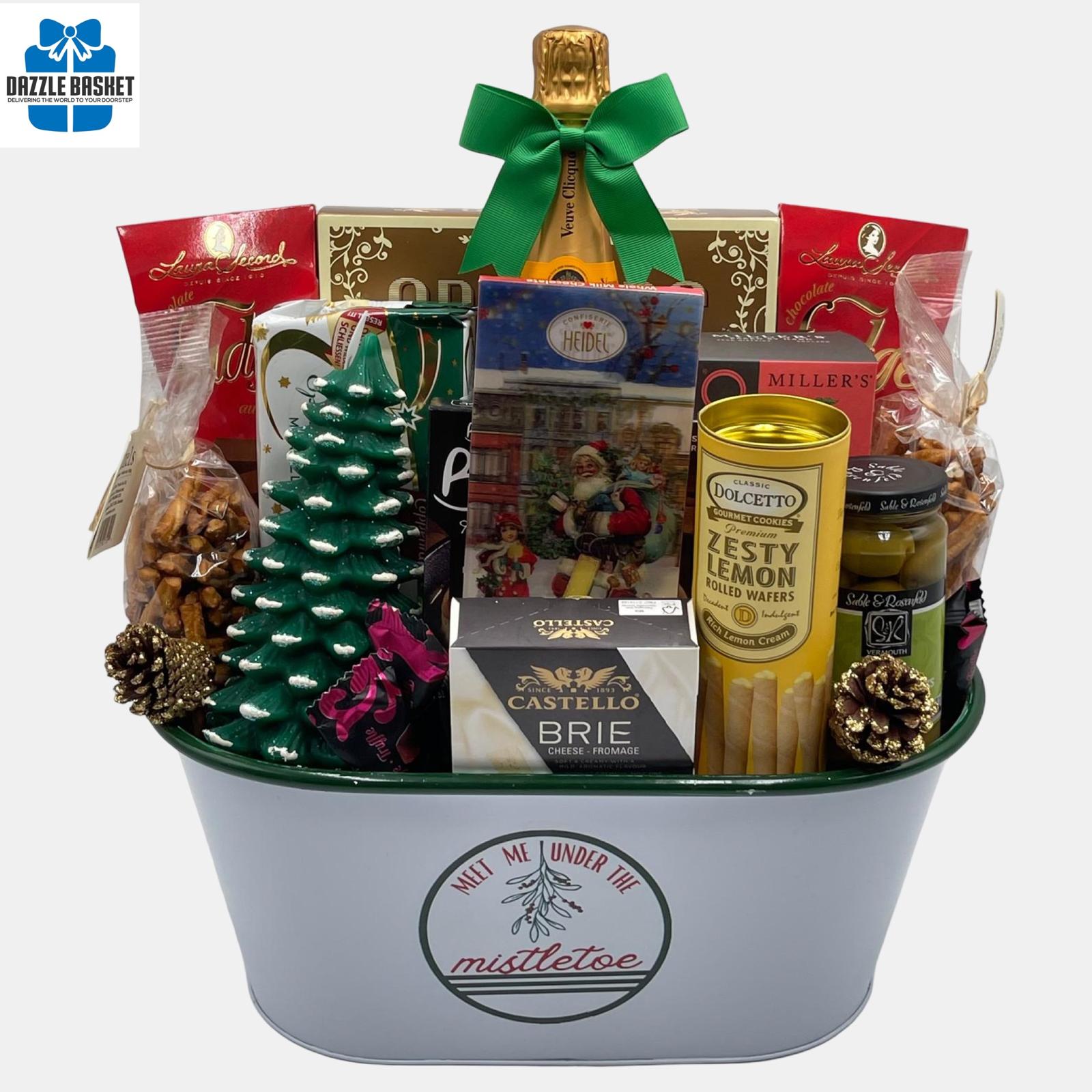 A holiday themed made in Calgary champagne gift basket that includes a 750 ml bottle of Veuve Clicquot champagne and delicious gourmet snacks arranged in a beautiful oval white "Mistletoe" container.
