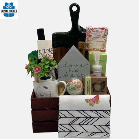 A Calgary housewarming gift basket with premium products including a bottle of wine, resin cheeseboard, gourmet and household products in a large brown wooden crate.