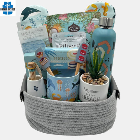 A housewarming basket containing useful items for the new home owner arranged beautifully in a oval grey cotton basket with handles.