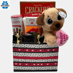 Finest Love gift baskets Calgary offers-This beautiful ombre hearts gift basket comes with an adorable plush toy with delicious gourmet food snacks.