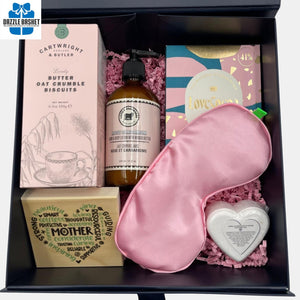 A custom Mother's Day gift box that includes a wooden plaque, chocolates, & spa products.