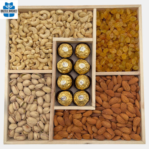 A sectional wooden tray  filled with over 1 kg. of tasty products including pistachio, almonds, cashews, golden raisins and chocolates. 