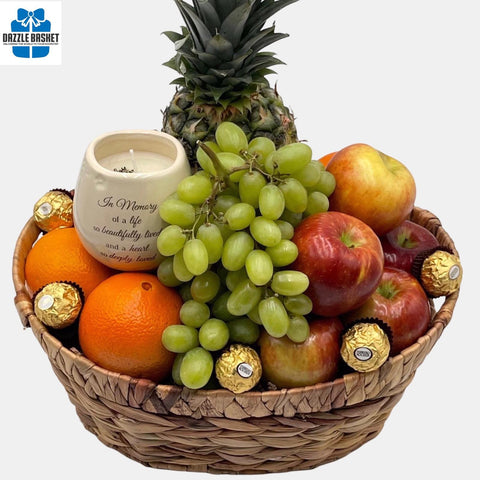A made in Calgary sympathy gift basket comprising of quality gourmet snacks, fruits and soya wax candle arranged in a large oval shaped hyacinth basket.