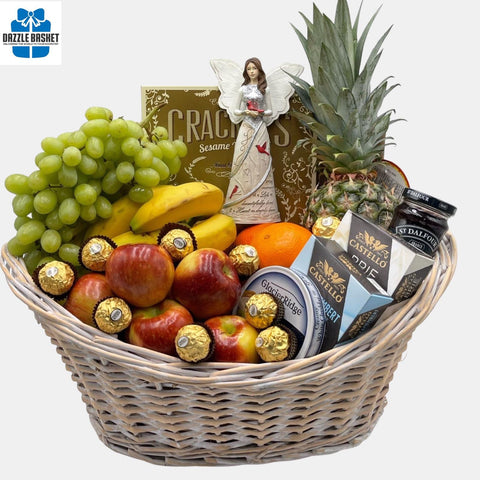 A made in Calgary sympathy gift basket comprising of quality gourmet snacks, fruits and an angel figurine arranged in a large oval shaped wooden basket.