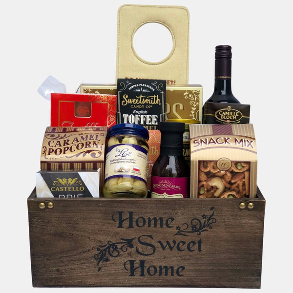 A made in Calgary Housewarming gift basket filled with tasty gourmet treats packed in a wooden basket titled "Home Sweet Home".
