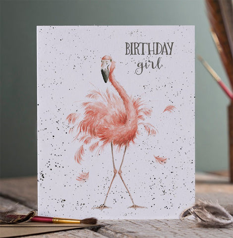 A birthday greeting card that depicts a flamingo and is meant for a girl. 