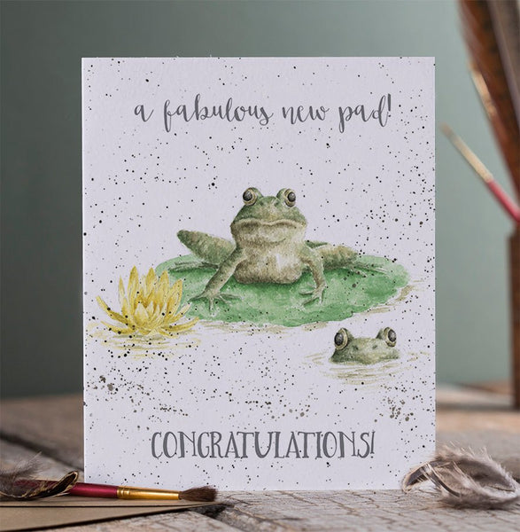 A greeting card for the New Home Owner. This card has a picture of a frog sitting on a leaf - his pad
