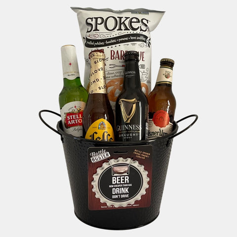 A made in Calgary beer gift basket made in a black metal container that contains four bottles of premium beer, chips and a bottle opener.