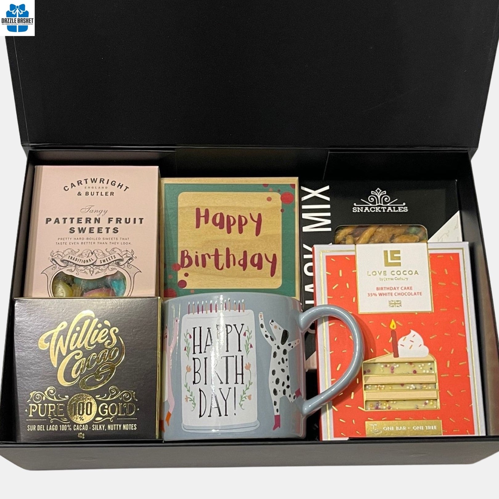 A birthday themed gift box that includes a birthday plaque, mug, chocolate in addition to other gourmet snacks.