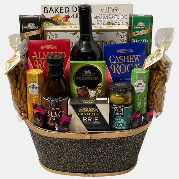A made in Caqlgary gift basket that includes an award winning red wine, delicious gourmet snacks organized neatly in a cream golden container. It is one of our most popular basket.