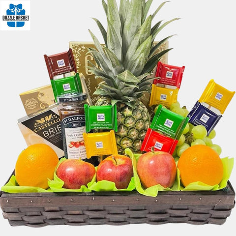 A made in Calgary fresh fruits basket in addition to chocolates, crackers, jam, truffles and cheese arranged neatly in rectangular brown woodchip tray.