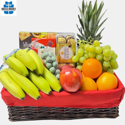 A made in Calgary fruit gift basket that includes fresh fruits, chocolates, crackers & cookies arranged neatly in a wicker basket with red liner.