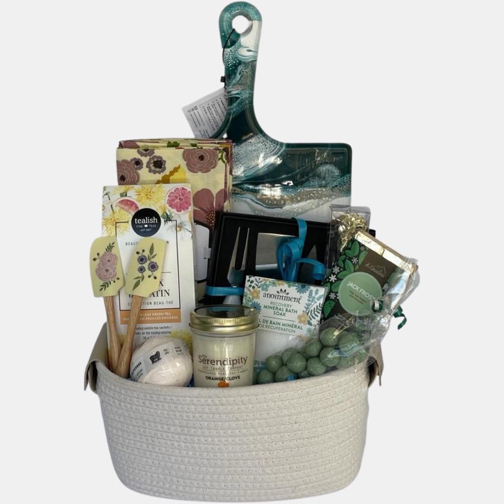Centered around an epoxy resin accented cheeseboard, this Calgary housewarming gift basket has a number of quality products that the new homeowner will use for years to come.