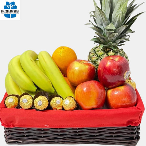 A made in Calgary fresh fruits basket in addition to chocolatesarranged neatly in rectangular brown basket with a red liner.
