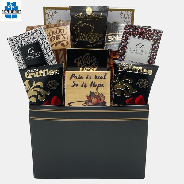 A Calgary gift basket that includes quality gourmet products from top global brands in a rectangular black and golden paper box.