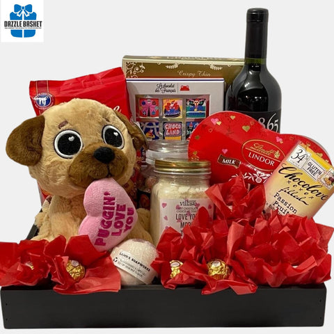 Valentine Gift Basket Calgary from Dazzle Basket- A perfect made in Calgary love gift basket that includes love themed red colored products , plushy and a wine arranged beautifully in a reusable black wooden tray.