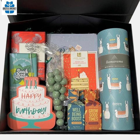 A birthday themed gift box that includes a birthday plaque, water bottle, plant seeds and chocolate in addition to other gourmet snacks.