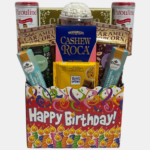 A made in Calgary birthday gift basket that includes delicious gourmet snacks including chocolates packed in a colorful large paper box