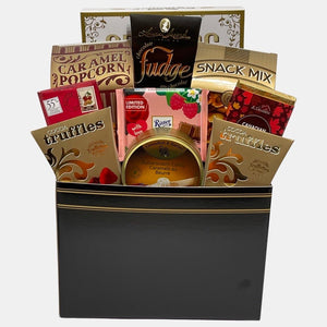 A Calgary gift basket that includes quality gourmet products from top global brands in a rectangular black and golden paper box.