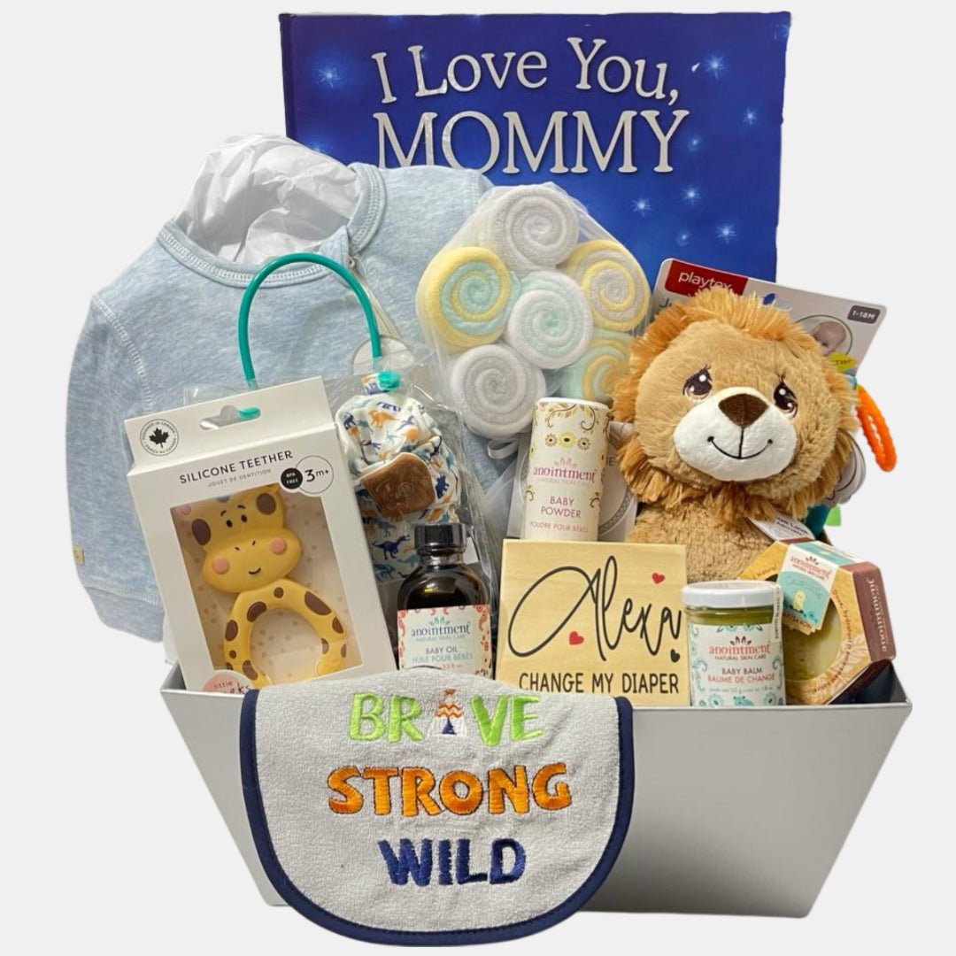 A beautiful made in Calgary baby gift basket that includes baby skin care and bath products, baby book, clothes and pair of shoes. The contents are arranged neatly in a grey carboard box.