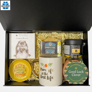 A custom Calgary gift box which includes a beautiful mug, compact mirror, seed sprouting kit and much more in a black magnetic box.