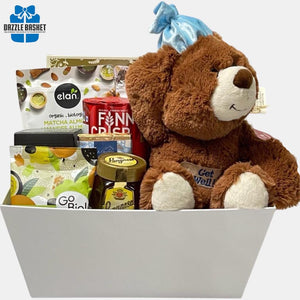 A made in Calgary Get well soon gift basket with delicious gourmet snacks and "Get Well" teddy packed in a large rectangular open box..