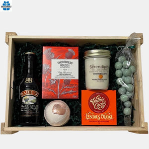 A collection of Irish cram Liqueur along with delicious gourmet and spa products arranged in a rectangular wooden tray. 