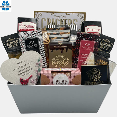 A made in Calgary sympathy gift basket comprising of quality gourmet snacks arranged in a large black metal container.