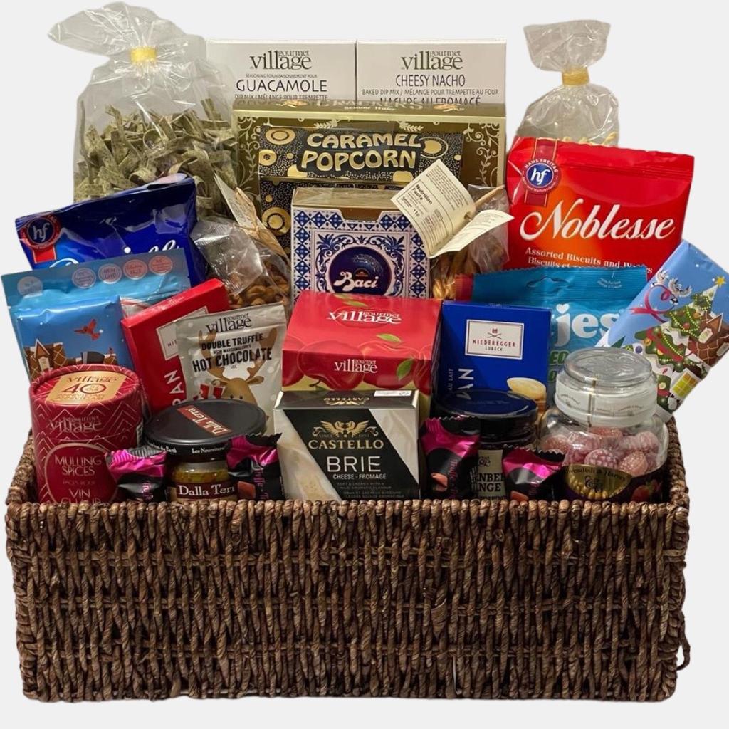 A stupendous made in Calgary gourmet gift basket with delicious gourmet snacks in a large willow baskets