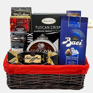 A made in Calgary gourmet gift basket that includes top of the line delicious gourmet snacks in a rectangular basket with red liner.