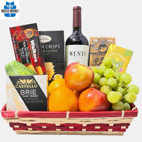 A made in Calgary fruit gift basket that includes fresh fruits, a bottle of wine, chocolates, crackers, truffles and shortbread cookies arranged neatly in a rectangular basket.