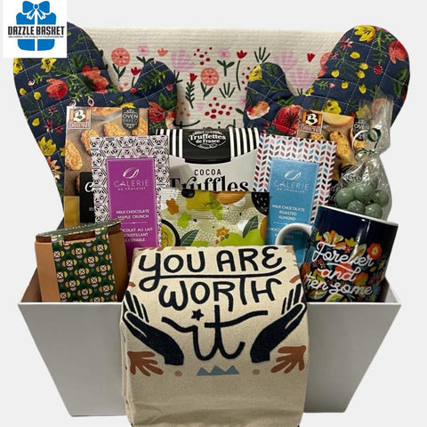 A housewarming basket containing useful item for the new home owner arranged beautifully in a large white market tray.