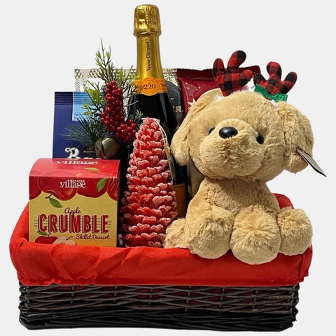 A rectangular basket with red liner that comes with a Veuve Cliquot champagne bottle, stuffed toy, candle and delicious gourmet snacks.
