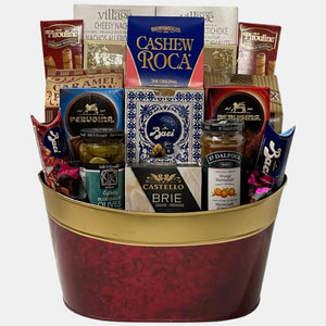 A holiday themed made in Calgary gift basket that includes delicious gourmet snacks in a beautiful red and gold metal container.