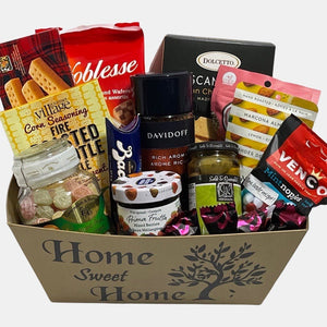 A made in Calgary Housewarming gift basket filled with tasty gourmet treats packed in a large container titled "Home Sweet Home".